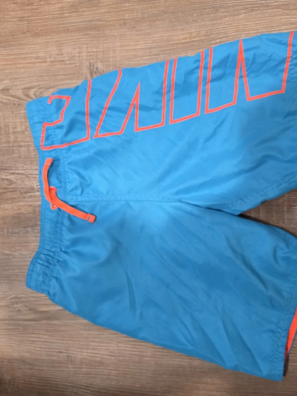 Nike Kids Blue Swim Trunks with Orange Accents